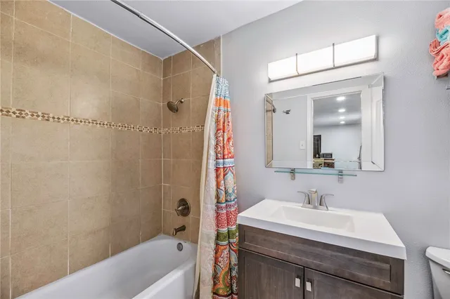 a bathroom with a sink a mirror and a bathtub