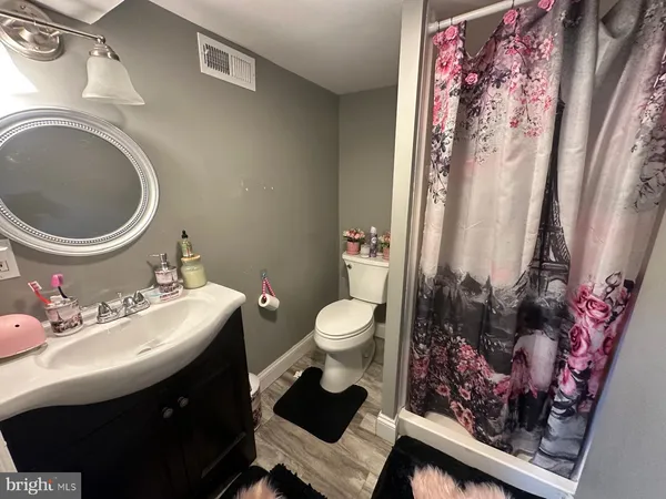 a bathroom with a sink mirror vanity and toilet
