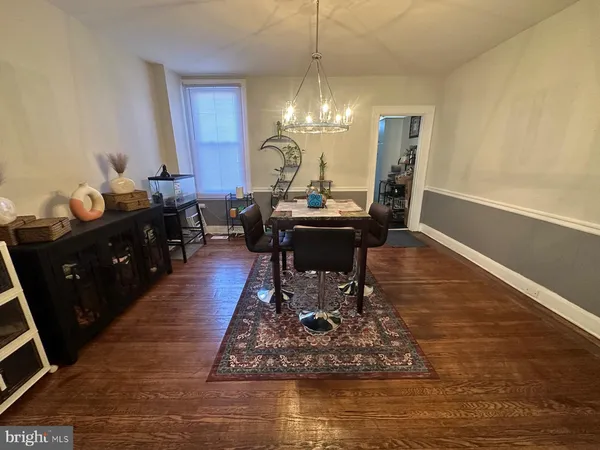 a living room with dining table and chairs
