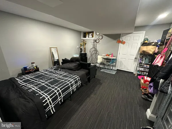a bedroom with bed and a flat tv screen