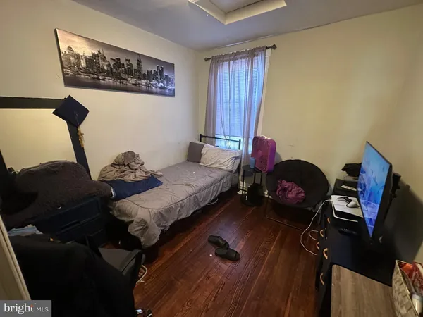 a bedroom with furniture and a window