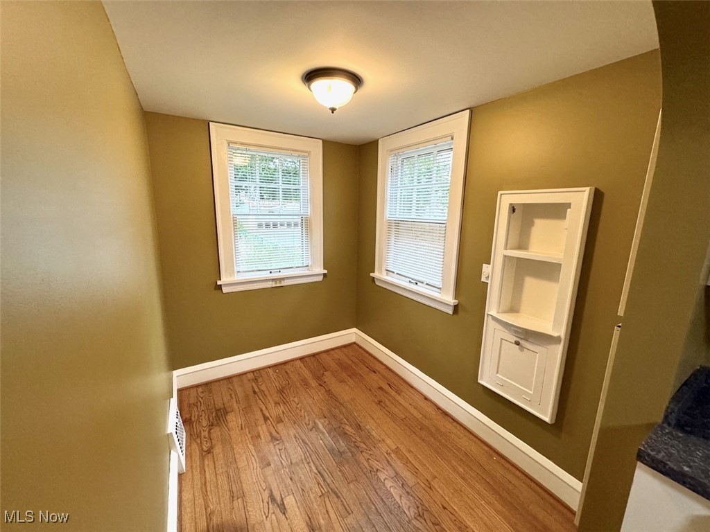 1011 Rushleigh Road Cleveland, OH 44121 - Photo 11 of 27 Breakfast nook with hardwood floors and built-in shelving