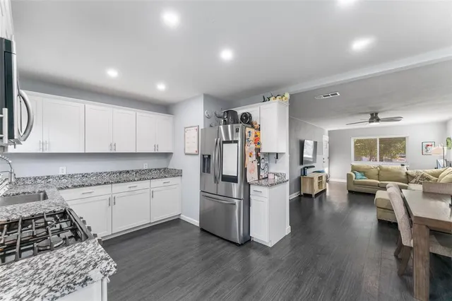 a kitchen with sink refrigerator and cabinets