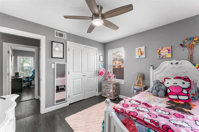 a bedroom that has a bed and a table in it