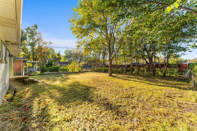 a view of yard with swimming pool and trees