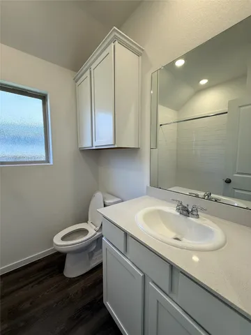 a bathroom with a sink toilet and vanity
