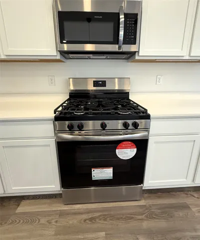 a stove top oven sitting inside of a kitchen
