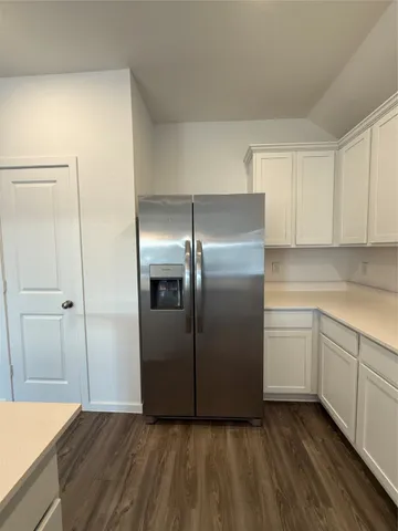 a kitchen with cabinets and stainless steel appliances
