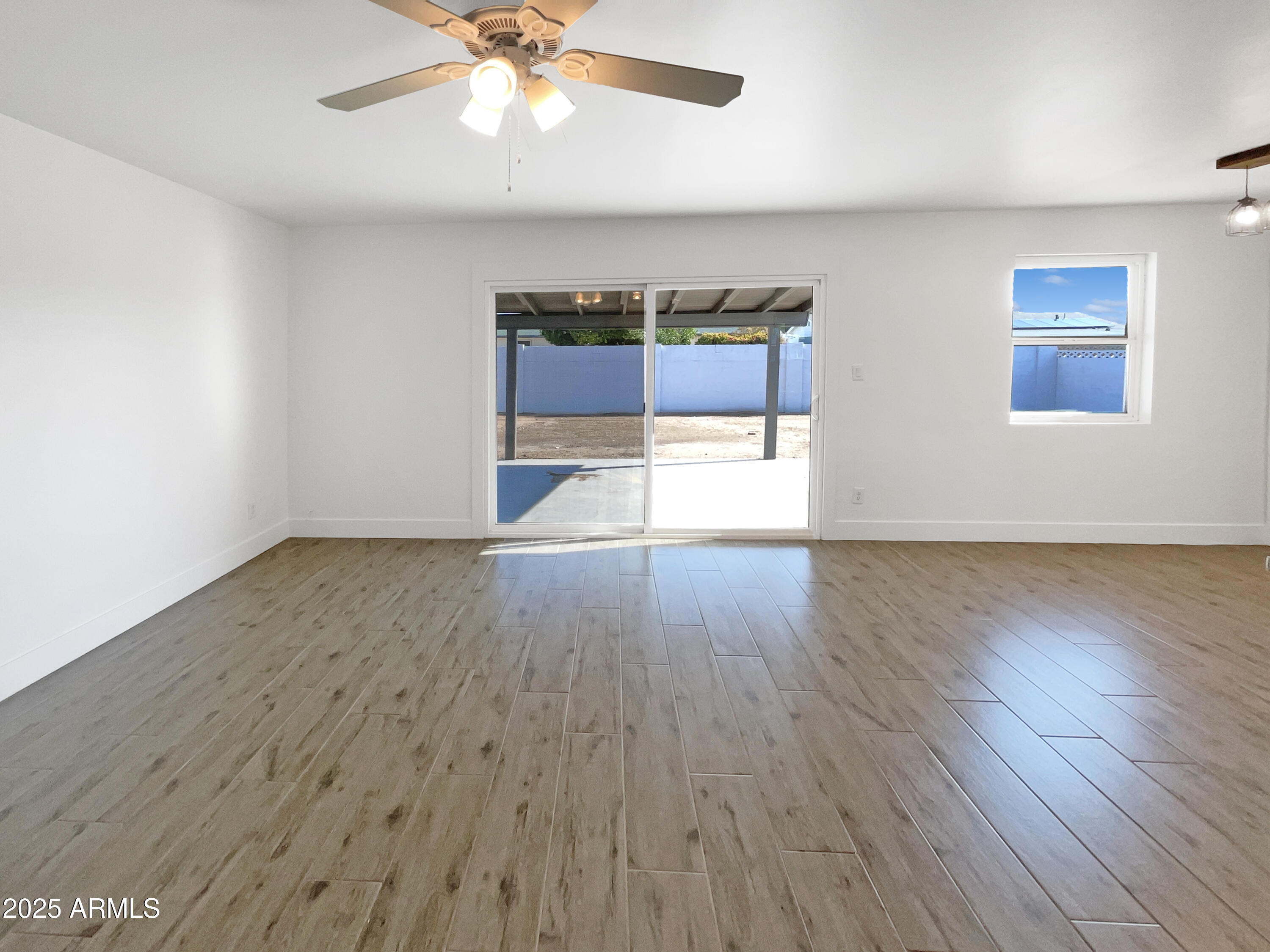 7231 North 23rd Avenue Phoenix, AZ 85021 - Photo 3 of 28 wooden floor in an empty room with a window