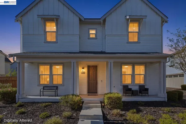 a view of a house with many windows and a yard