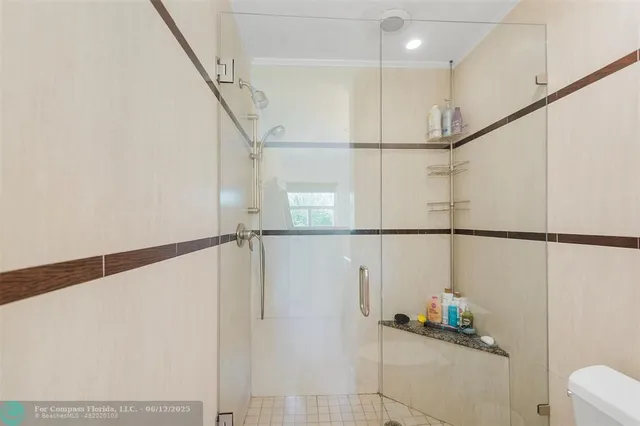 a bathroom with a granite countertop sink a large mirror and a bathtub