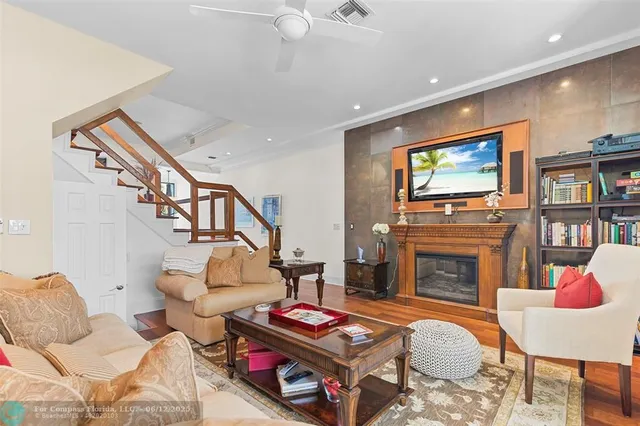 a dining room with stainless steel appliances granite countertop a stove and a wooden floors