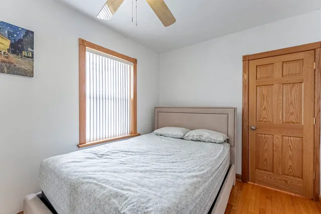 a large bed in a bedroom next to a window