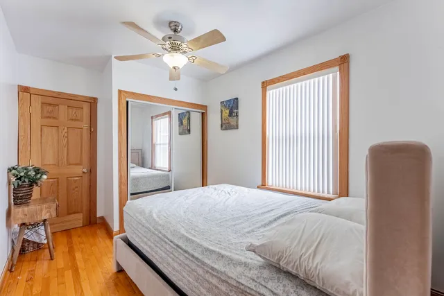 a bedroom with a large bed and a chandelier