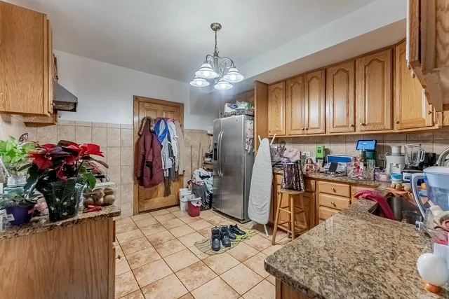 a kitchen with refrigerator and cabinets