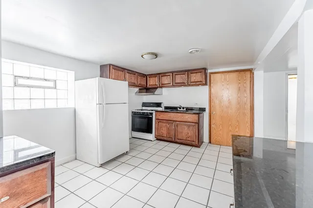 a kitchen with a refrigerator sink and cabinets