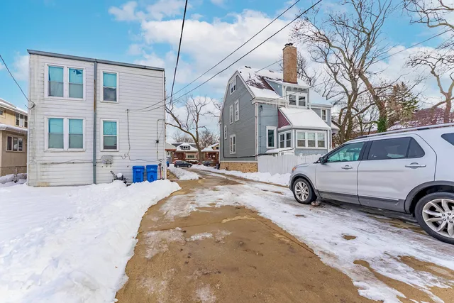 a view of a house with a snow in front of building
