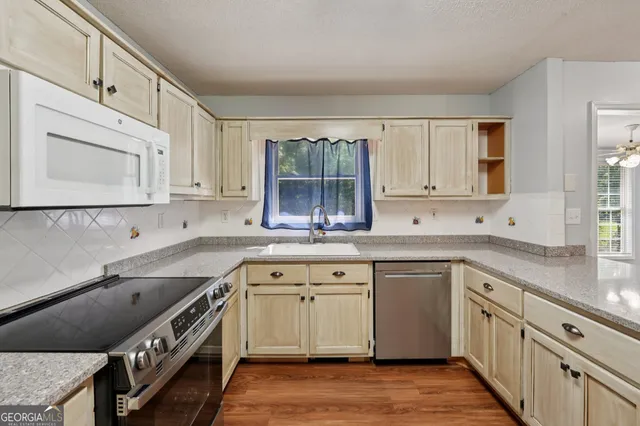 a kitchen with a sink stove and cabinets