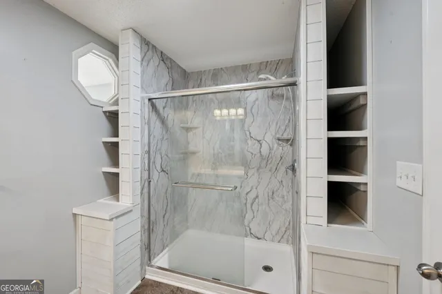 a bathroom with a glass shower door