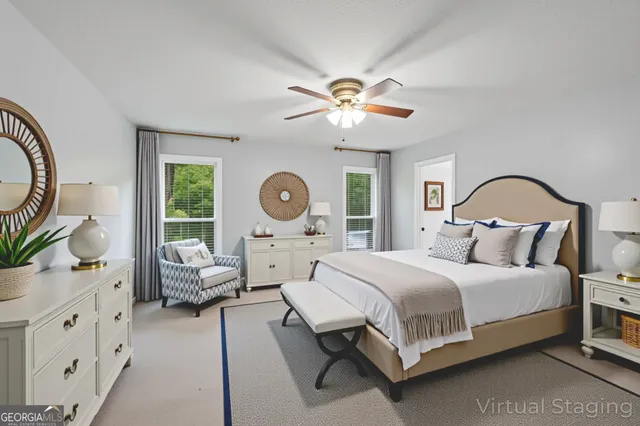 a bedroom with a bed chandelier and a window
