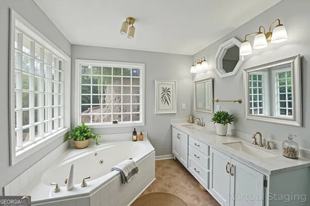 a spacious bathroom with a granite countertop tub and a large window