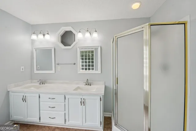 a bathroom with double vanity sink and mirror