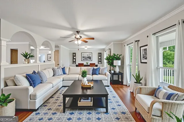 a living room with furniture fireplace and a large window