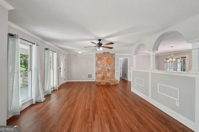 wooden floor in an empty room with a window