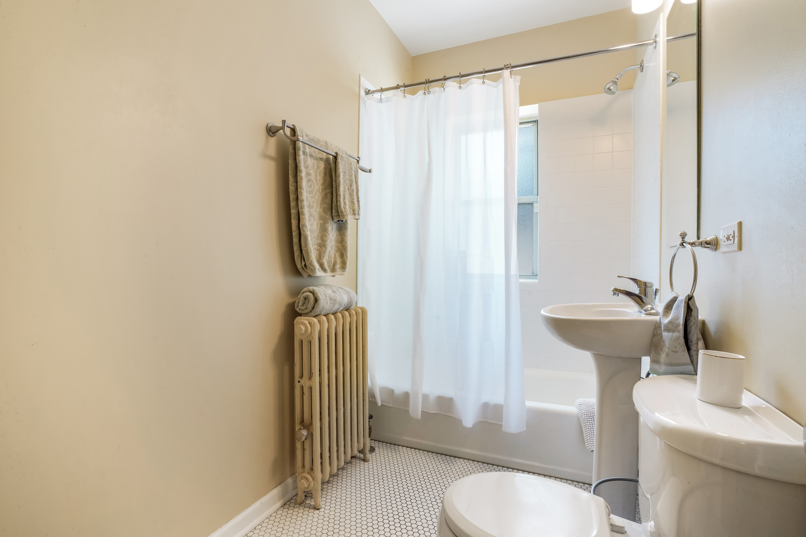 2018 West Greenleaf Avenue, Unit 1F Chicago, IL 60645 - Photo 11 of 12 a bathroom with a sink toilet and shower