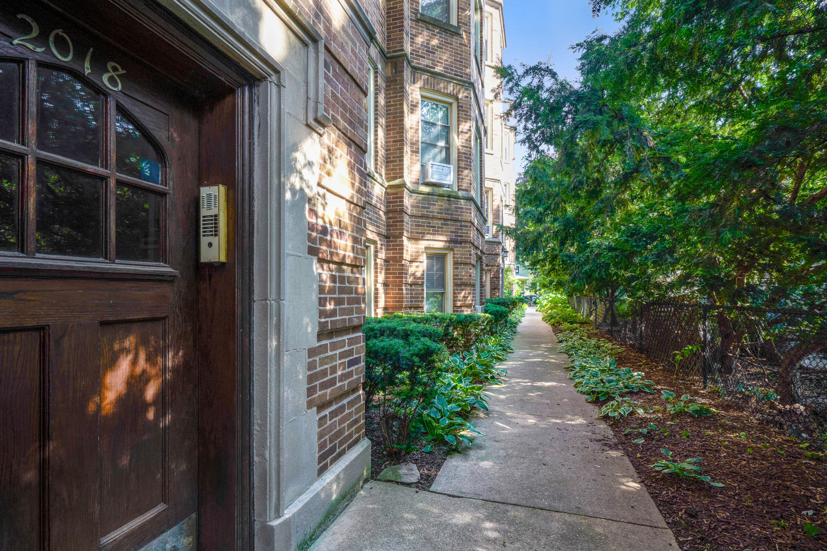 2018 West Greenleaf Avenue, Unit 1F Chicago, IL 60645 - Photo 4 of 12 a view of a pathway both side of building