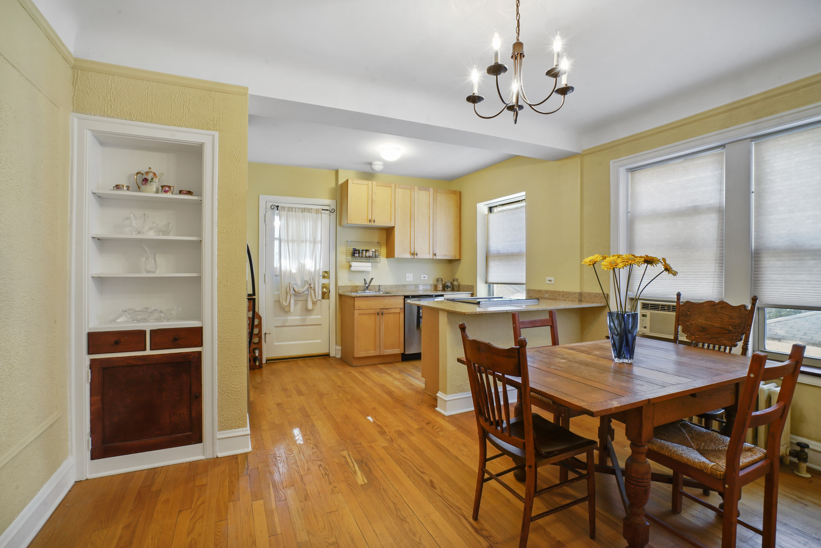 2018 West Greenleaf Avenue, Unit 1F Chicago, IL 60645 - Photo 6 of 12 a view of a dining room with furniture and a chandelier