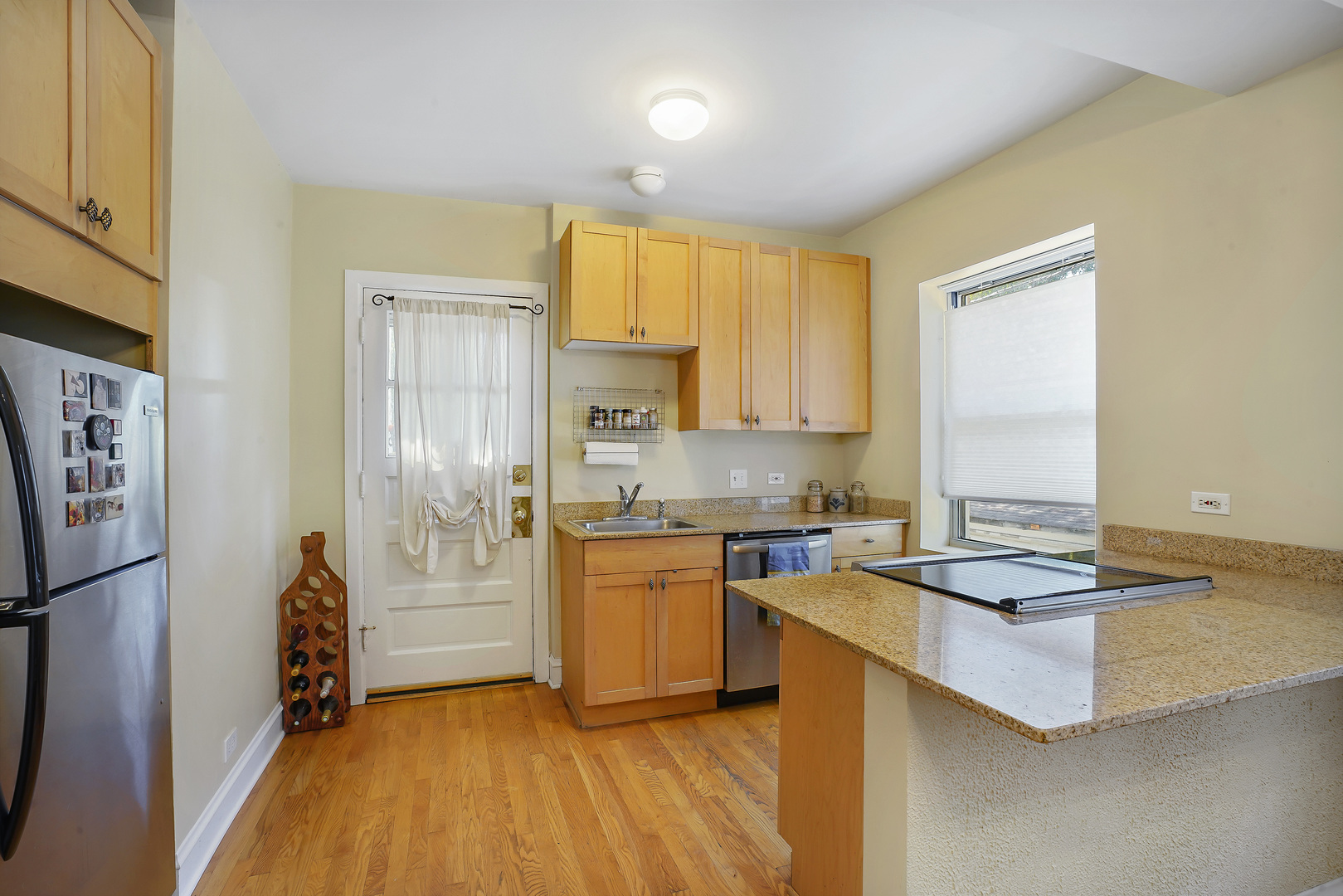 2018 West Greenleaf Avenue, Unit 1F Chicago, IL 60645 - Photo 8 of 12 a kitchen with granite countertop a stove a sink dishwasher and a refrigerator