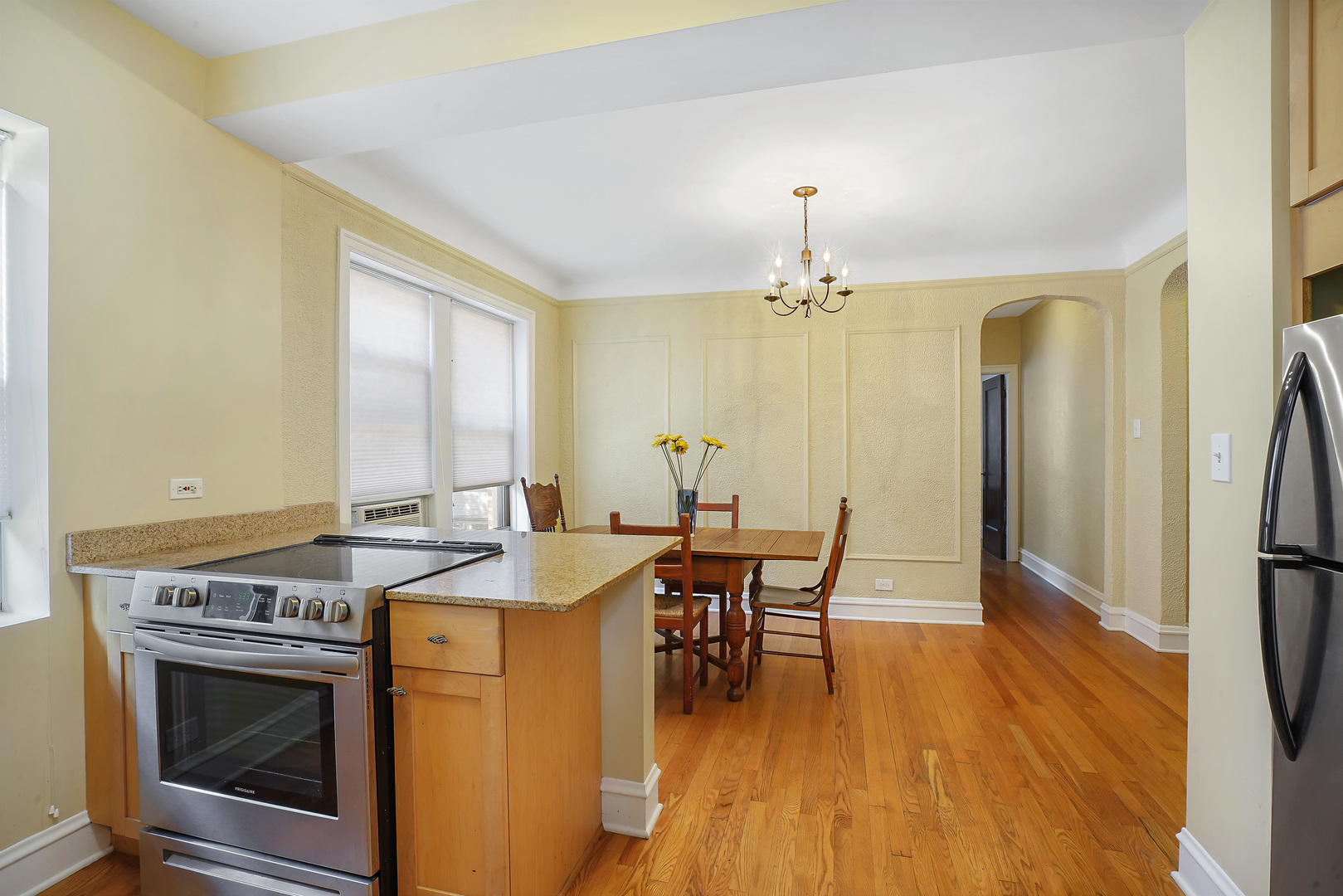 2018 West Greenleaf Avenue, Unit 1F Chicago, IL 60645 - Photo 9 of 12 a view of a dining room with furniture and chandelier