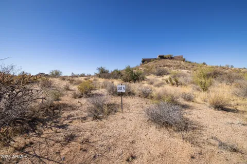 a view of a large building with mountains in the background