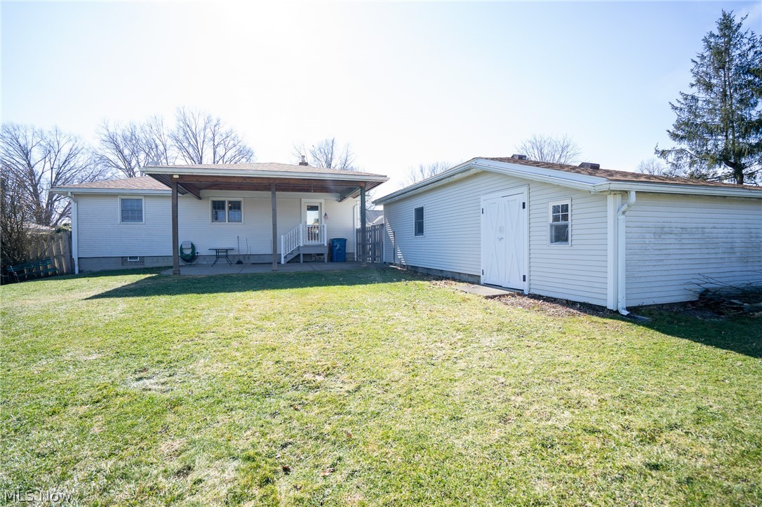 453 Omar Street Struthers, OH 44471 - Photo 8 of 27 Back of house featuring a yard, a patio area, and an outbuilding