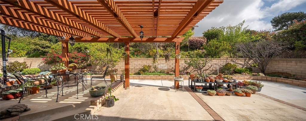 23419 Sandridge Road Diamond Bar, CA 91765 - Photo 14 of 51 a view of a patio with table and chairs and potted plants