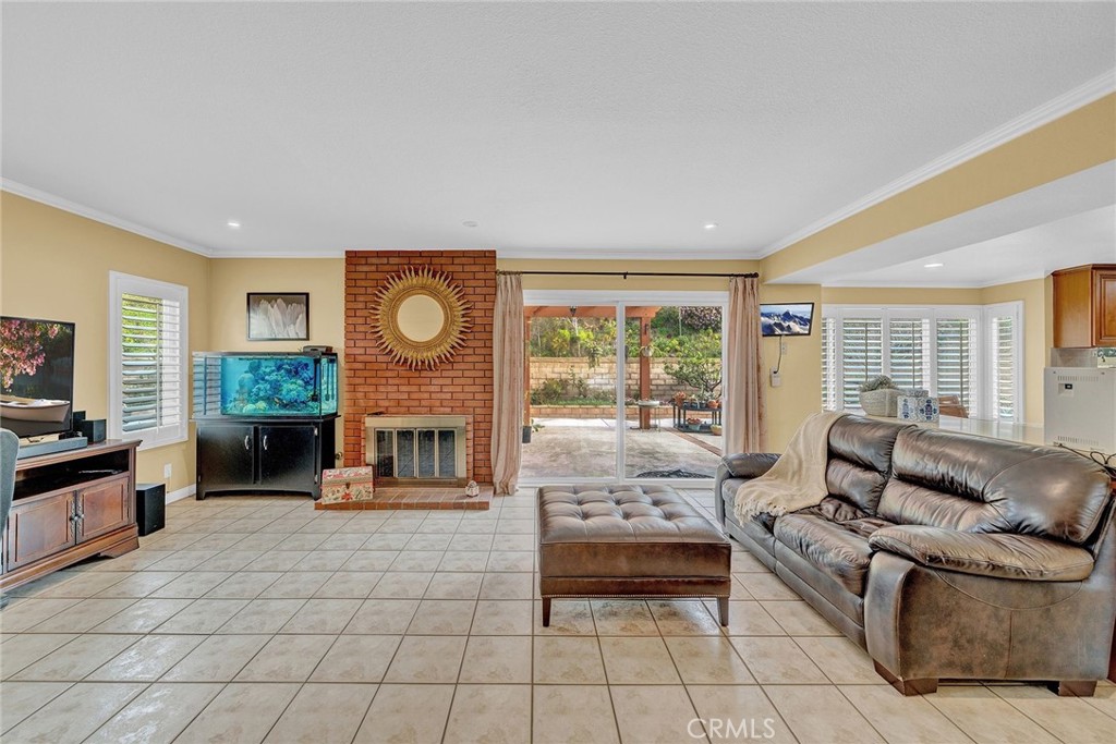 23419 Sandridge Road Diamond Bar, CA 91765 - Photo 25 of 51 a living room with furniture a fireplace and a flat screen tv