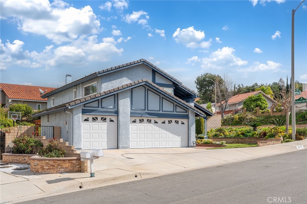 23419 Sandridge Road Diamond Bar, CA 91765 - Photo 3 of 51 a front view of a house with a yard and garage