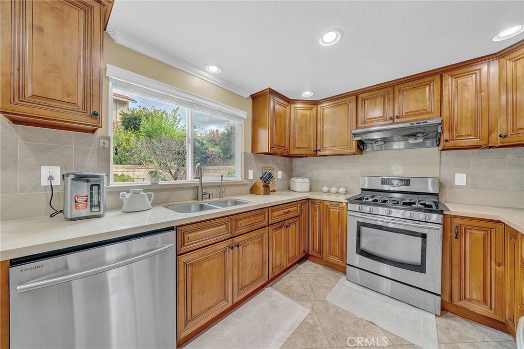 23419 Sandridge Road Diamond Bar, CA 91765 - Photo 32 of 51 a kitchen with stainless steel appliances granite countertop a sink a stove and a refrigerator