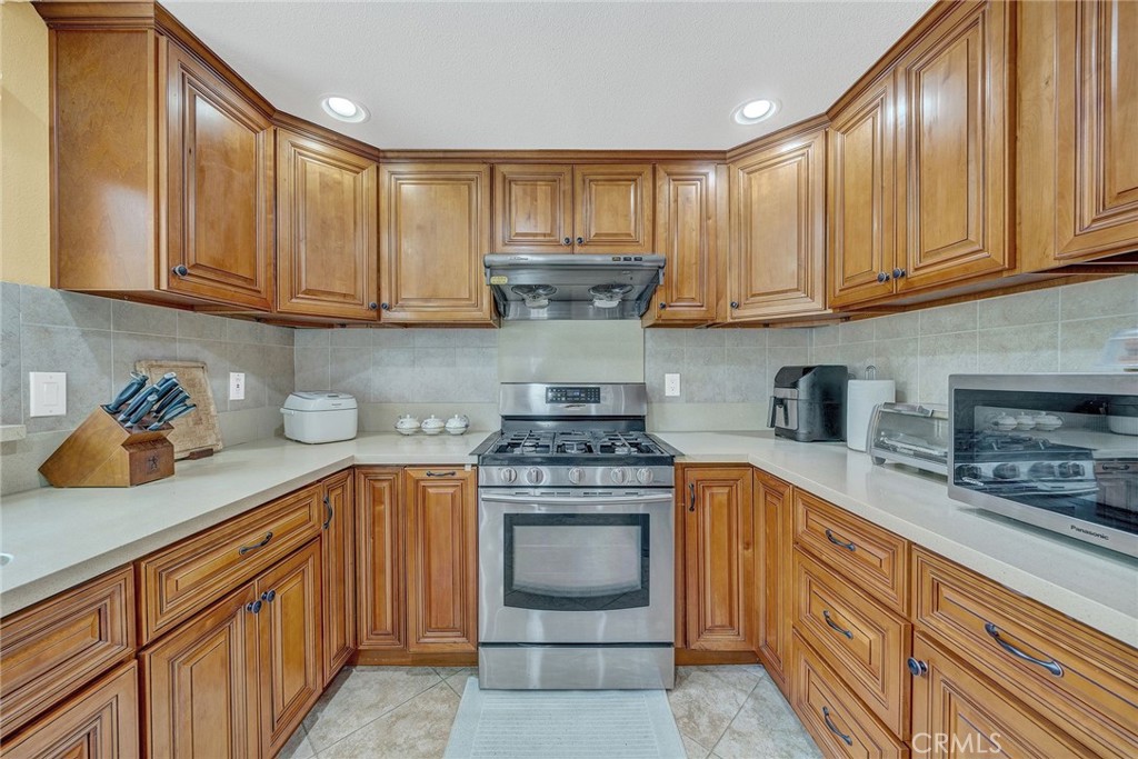 23419 Sandridge Road Diamond Bar, CA 91765 - Photo 33 of 51 a kitchen with stainless steel appliances granite countertop a stove sink and cabinets
