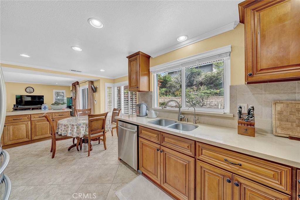 23419 Sandridge Road Diamond Bar, CA 91765 - Photo 34 of 51 a kitchen with a sink dining table and chairs