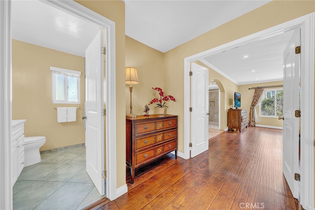 23419 Sandridge Road Diamond Bar, CA 91765 - Photo 38 of 51 a view of a hallway with bathroom and wooden floor
