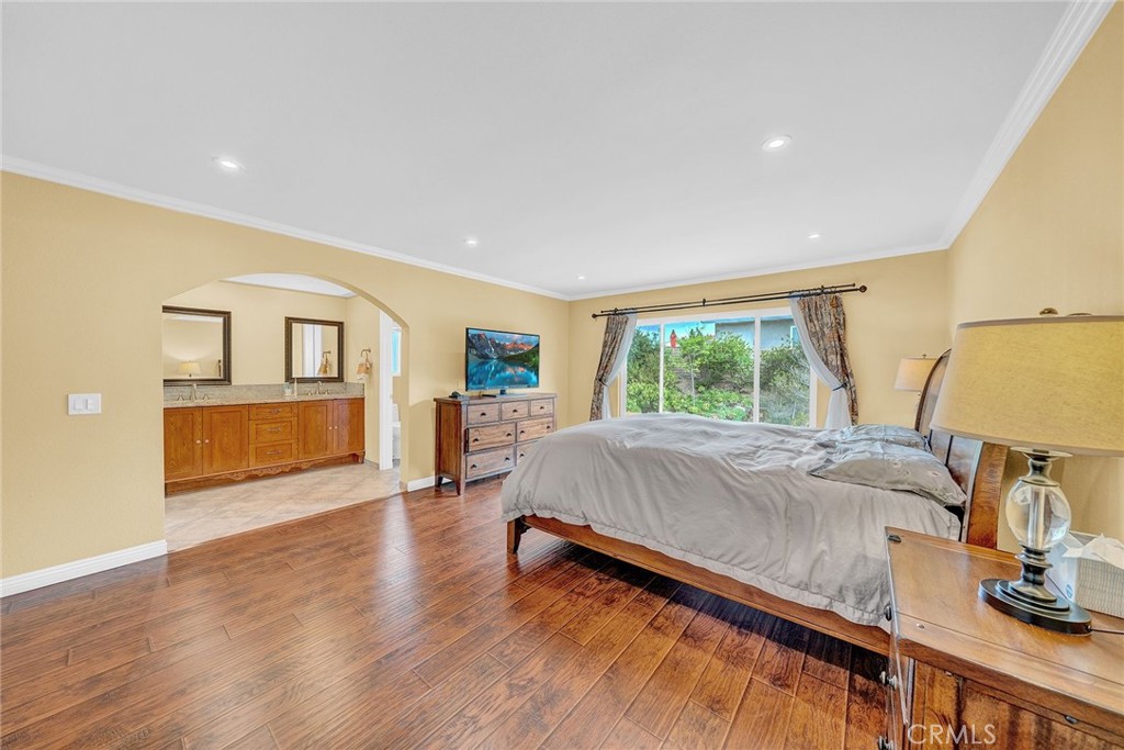 23419 Sandridge Road Diamond Bar, CA 91765 - Photo 41 of 51 a spacious bedroom with a bed and wooden floor