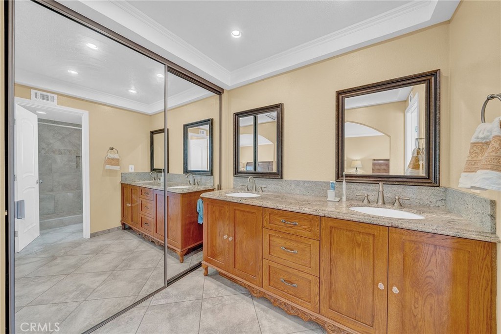 23419 Sandridge Road Diamond Bar, CA 91765 - Photo 45 of 51 a bathroom with a granite countertop sink mirror and double