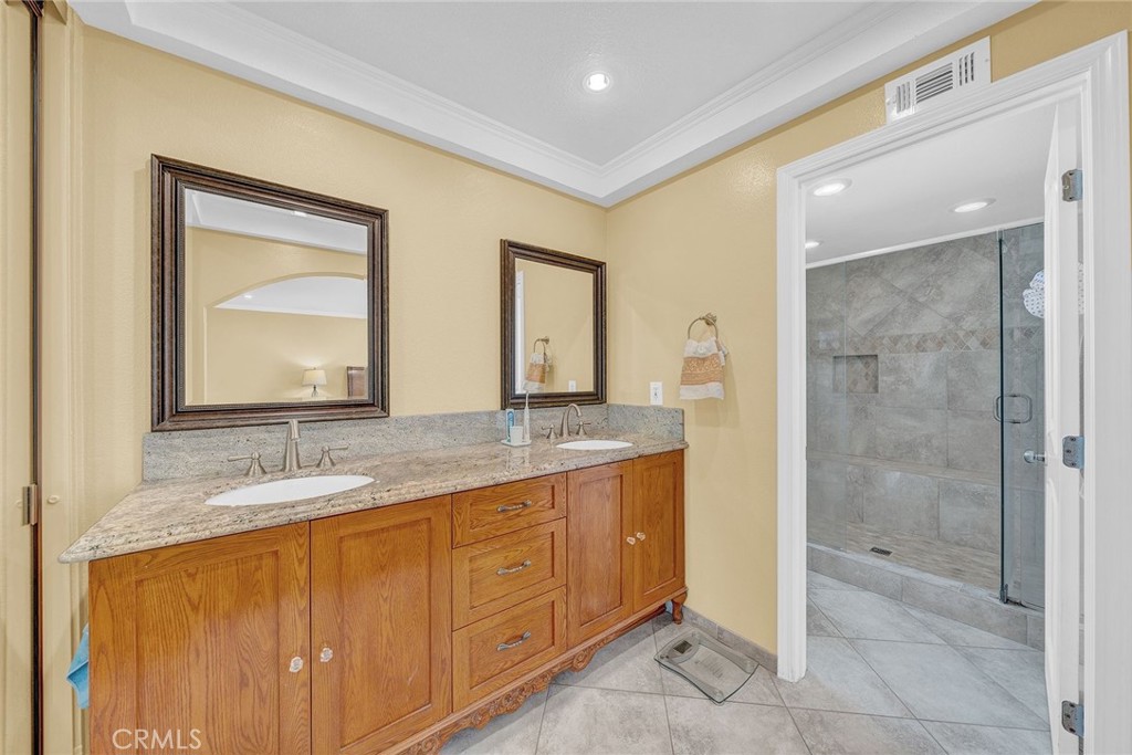 23419 Sandridge Road Diamond Bar, CA 91765 - Photo 46 of 51 a bathroom with a granite countertop sink mirror and double