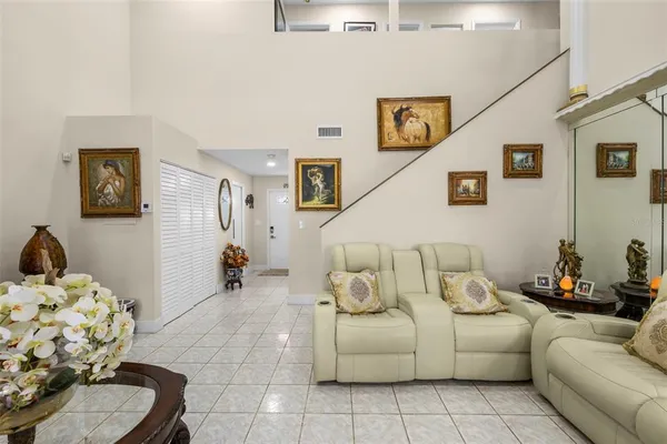a living room with furniture and painting on the wall