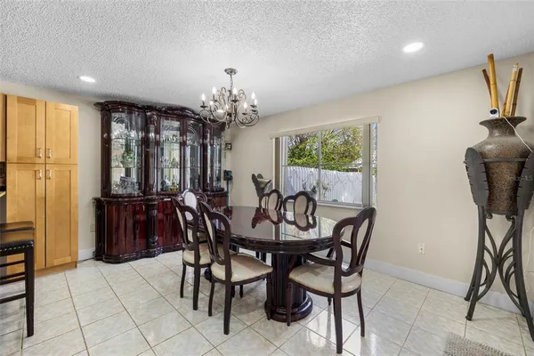 a view of a dining room with furniture and chandelier