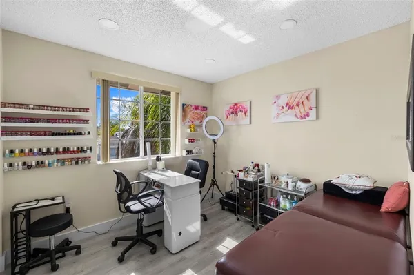 a view of a workspace with furniture and a window