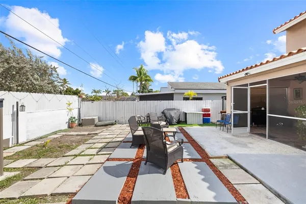 a view of a patio with dining table and chairs with wooden floor