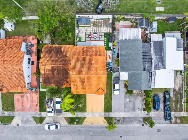 an aerial view of residential houses with outdoor space